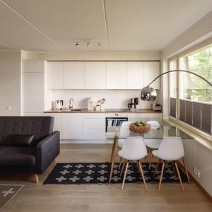 a kitchen with a couch and a table and chairs at W Apartments Torupilli, terrace, green yard, parking in Tallinn