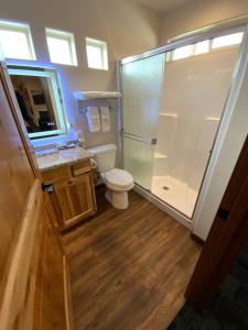 a bathroom with a shower and a toilet and a sink at Bear Mountain - Suite 4 in Grants Pass