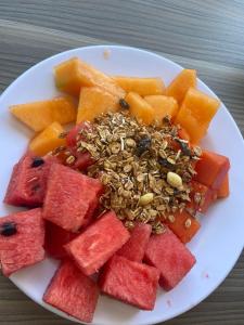 a plate of watermelon and fruit on a table at Al&oacute; Select Mazatlan in Mazatl&aacute;n