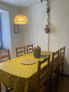 a dining room table with a yellow table cloth at L'Alsacienne in Rouffach