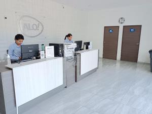two people working at computers in an office at Aló Select Mazatlan in Mazatlán