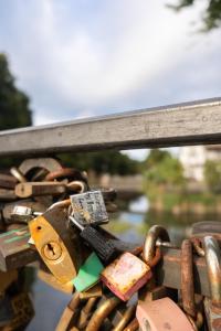 a couple of locks on a metal fence at KOWALSKA 8 APARTAMENTY ZRESETUJ SIĘ W GDAŃSKU in Gdańsk