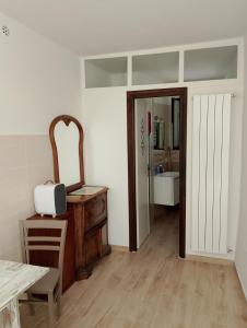 a room with a mirror and a dresser and a bathroom at Casa Vacanze Le Cannelle in Montefiascone +3 photos