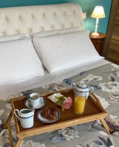 a bed with a tray of food and drinks on it at Vita Bella in Castagnole Monferrato