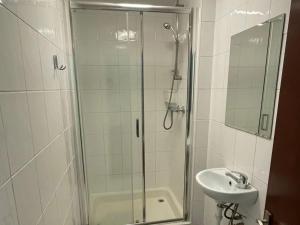 a bathroom with a shower and a sink at The Traders Inn in London