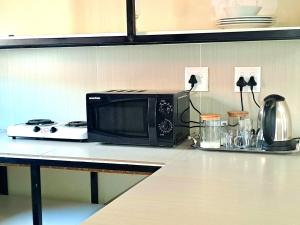 a microwave sitting on top of a kitchen counter at Residential Inn in Pretoria