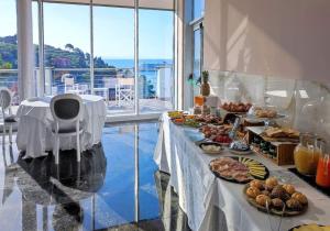 a buffet of food on a table in a room at Cristallo Park Hotel in Portovenere