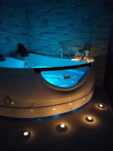 a bath tub with a blue light in a bathroom at Dolce Vita in Vinkovci