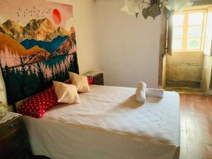a bedroom with a bed with a painting on the wall at Los Dos Hermanos in A Coruña