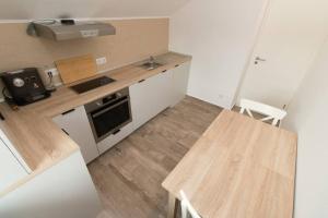 a small kitchen with a wooden table and a stove at Mountain Valley View in Buşteni