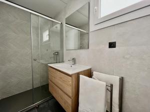 a bathroom with a sink and a shower with a mirror at NEW CAPUCHINOS Apartment 1 in Málaga +5 photos