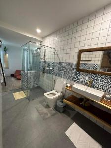 a bathroom with a shower and a toilet and a sink at Brook Villa Khaoyai in Pak Chong
