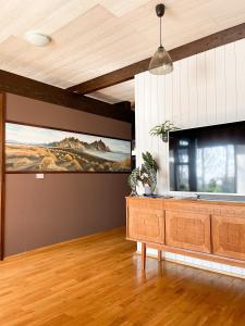 a living room with a large flat screen tv at Haukaberg House in Höfn