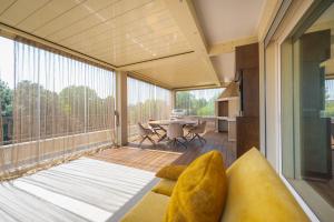 a screened in porch with a couch and a table at Venice New Luxury Penthouse with parking in Mestre