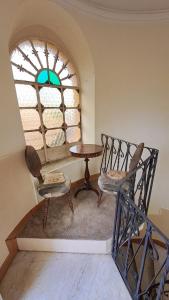 a room with a table and two chairs and a window at Villa Tessa in Ronciglione