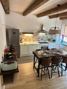 a kitchen with a table and chairs in a kitchen at Vita Bella in Castagnole Monferrato +35 photos