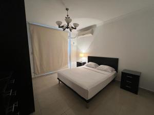 a bedroom with a white bed and a window at Madinaty, Elite new apartment with garden in Madinaty