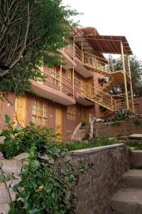 a pink building with stairs leading up to it at Casa Don Jose B & B in Puno