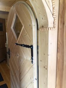 a door to a horse stall in a barn at Stara chałpa oźna in Sól