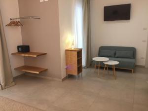 a living room with a couch and a table at LE RONDINI HOUSE in Monopoli