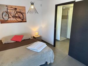 a bedroom with a bed with a bike on the wall at A la belle quatrième étoile in Annecy