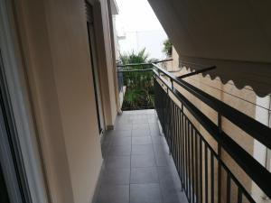 a view of a balcony with a door and a tile floor at Central Home in Kalamata