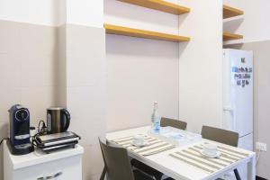 a kitchen with a table with chairs and a coffee maker at Ca' du Cila in Riomaggiore
