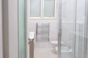 a white bathroom with a toilet and a sink at Ca' du Cila in Riomaggiore