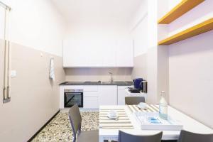 a kitchen and dining room with a table and chairs at Ca' du Cila in Riomaggiore +10 photos