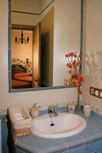 a bathroom with a sink and a large mirror at Casa Rural Cristina III in San Pablo de los Montes