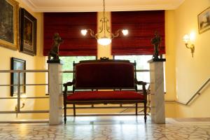 a chair in a room with a window at CASA IANUȘ in Breaza