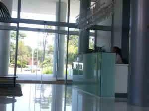 a building with a glass floor with a person in it at Torre Bellagio piso 14 Hermoso depto 3 personas in Punta del Este