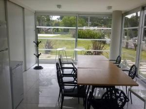 a table and chairs in a room with a large window at Torre Bellagio piso 14 Hermoso depto 3 personas in Punta del Este