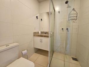 a bathroom with a shower and a toilet at AP encantador na Praia do Forte! Porto Azul (107) in Cabo Frio +25 photos