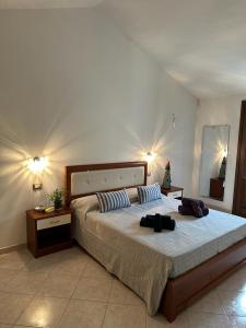 a bedroom with a large bed with two bags on it at Angela House in Teulada
