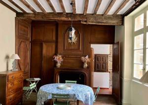 a dining room with a table and a fireplace at Appartement Intra-Muros - 2 chambres in Saint Malo