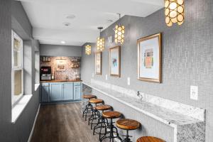 a row of stools in a kitchen with a bar at Alexandra Inn in Traverse City