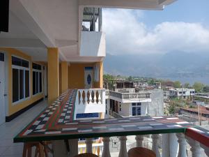 a balcony with a view of a building at CASA EMILY in San Pedro La Laguna