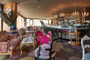 a room filled with furniture and a bar with a counter at Museum Apartment Hotel, Independent Collection by EVT in Wellington