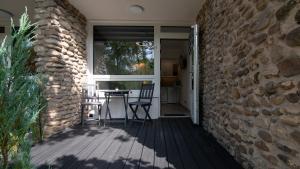 a patio with chairs and a stone wall at Barbara 11 in Ustroń