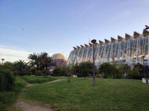 a large glass building with a park in front of it at Arts & Sciences Rooms - Bruno Valencia Apartments - Double Ensuite Rooms & Suites - Oceanografic - City of Arts and Sciences in Valencia