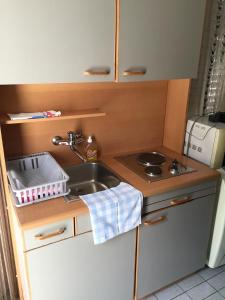 a small kitchen with a sink and a stove at Apartments Peace&Love in Baška