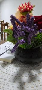 a vase filled with flowers sitting on a table at Superb 1 bedroom in the best zone of the city. in Ferizaj