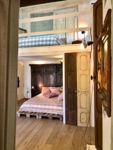 a bedroom with a bunk bed with pink pillows at Charming and Design Attic Loft Central Milan in coolest area Navigli Ticinese in Milan