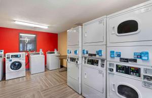 a laundry room with several washers and dryers at Extended Stay America Select Suites - Newport News - Oyster Point in Newport News
