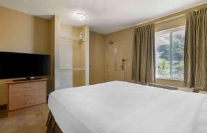 a bedroom with a large bed and a television at Extended Stay America Suites - Houston - The Woodlands in The Woodlands