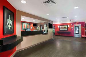 a lobby with a hair salon with red walls at Extended Stay America Suites - San Diego - Hotel Circle in San Diego