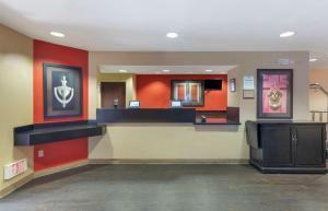 a waiting area in a hospital with red walls at Extended Stay America Suites - Orange County - Yorba Linda in Anaheim