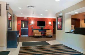 a lobby with a waiting room with a table and chairs at Extended Stay America Suites - Detroit - Canton in Canton