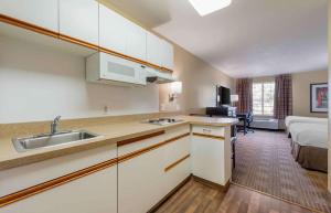 a kitchen with a sink and a bed in a room at Extended Stay America Suites - Minneapolis - Eden Prairie - Technology Drive in Eden Prairie